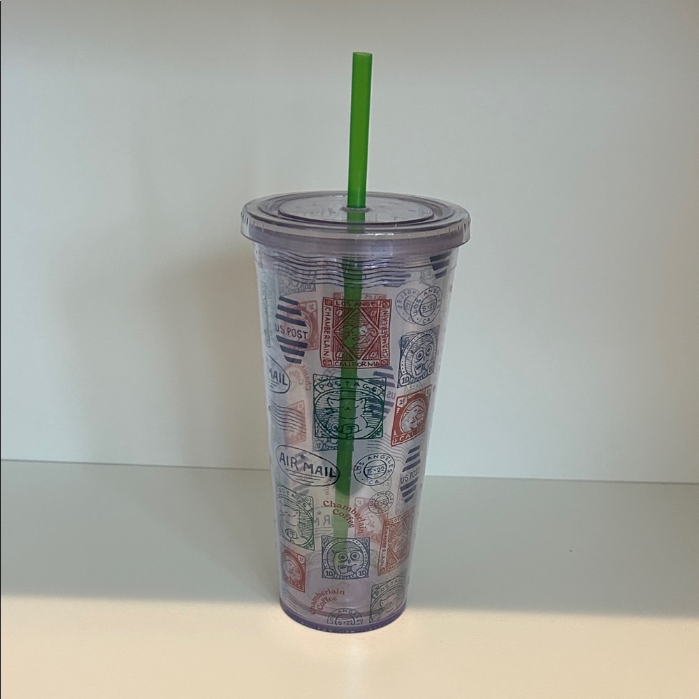 Clear Travel Tumbler with Green Straw and Postage-Stamp Motif